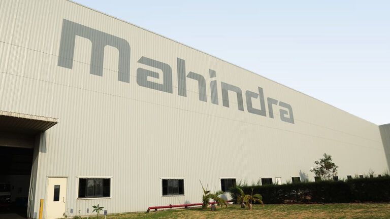 Mahindra logo over a factory